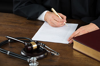 Judge signing a court document